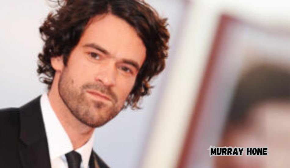 Murray Hone in a candid outdoor photo wearing a casual jacket.